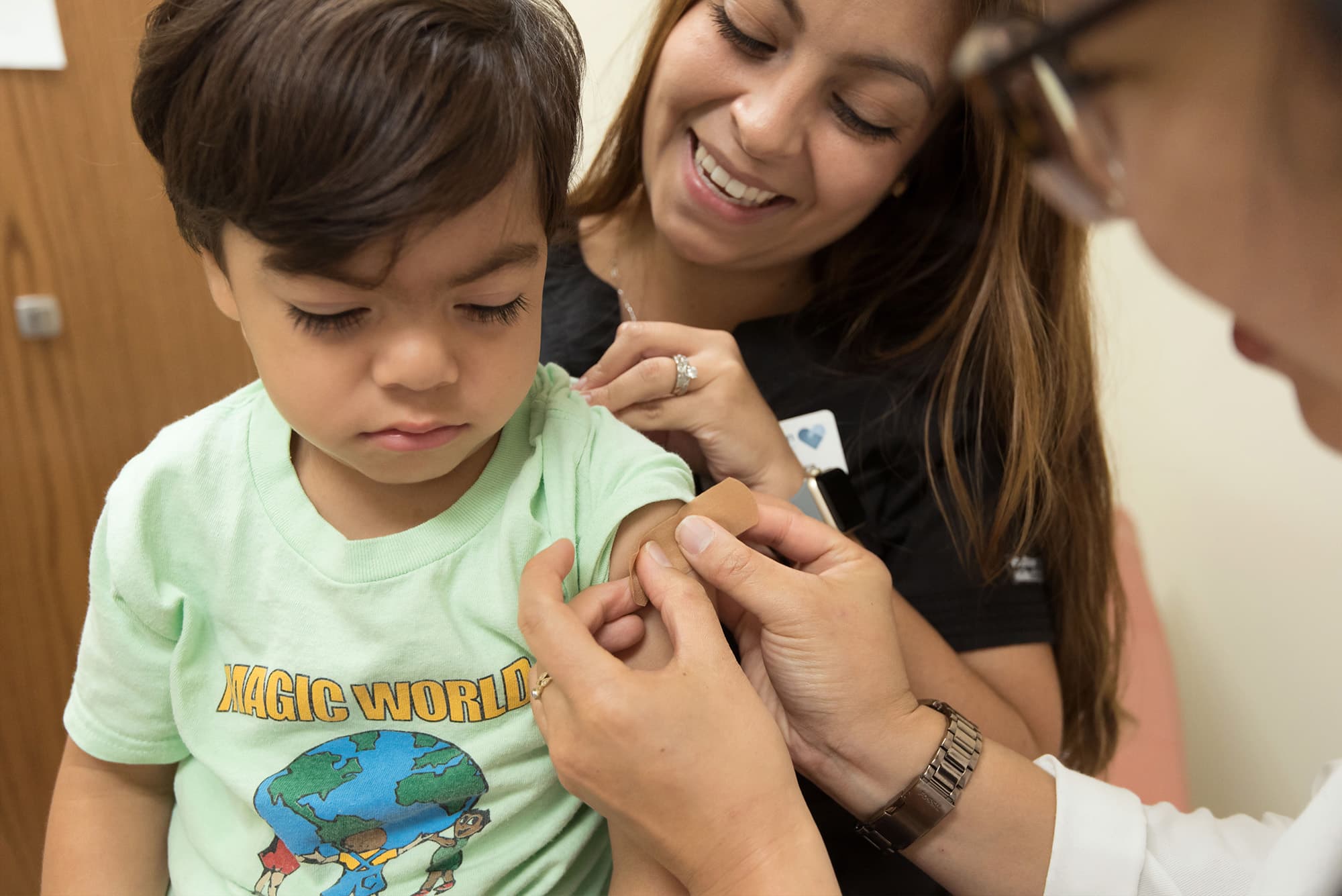 Healthcare professional checking child's blood pressure