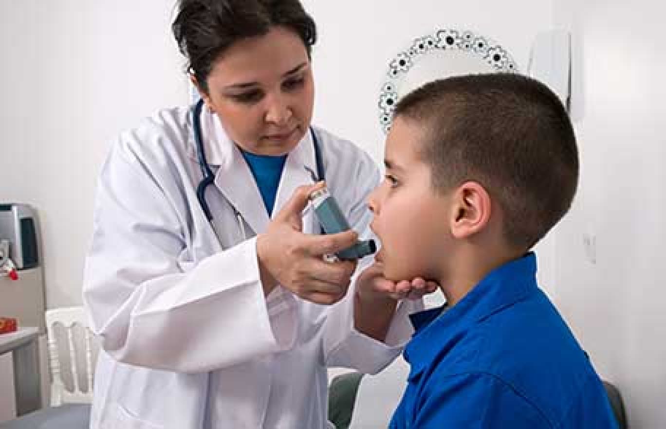 nurse aiding child with an inhaler