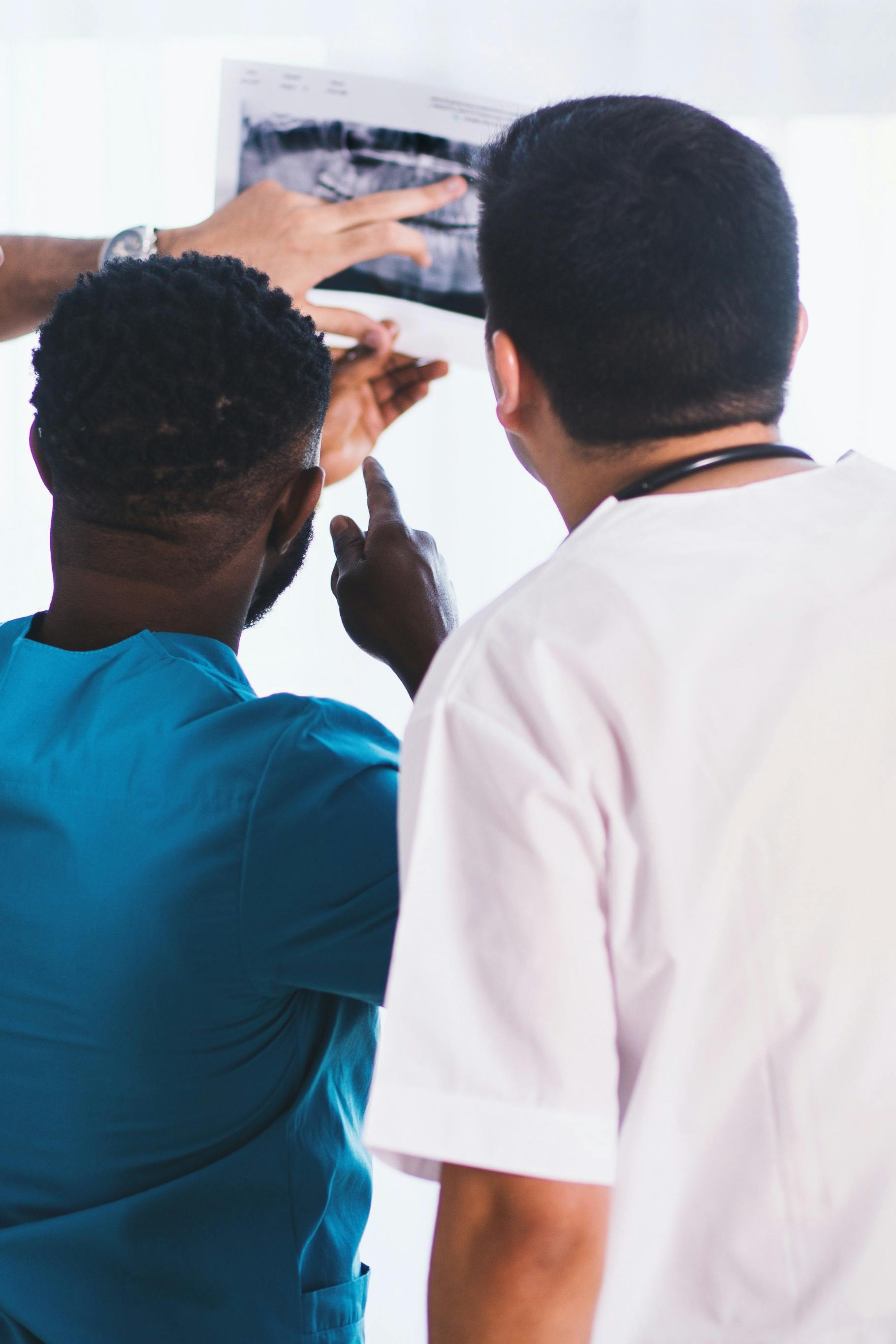 Health professionals examining an x-ray