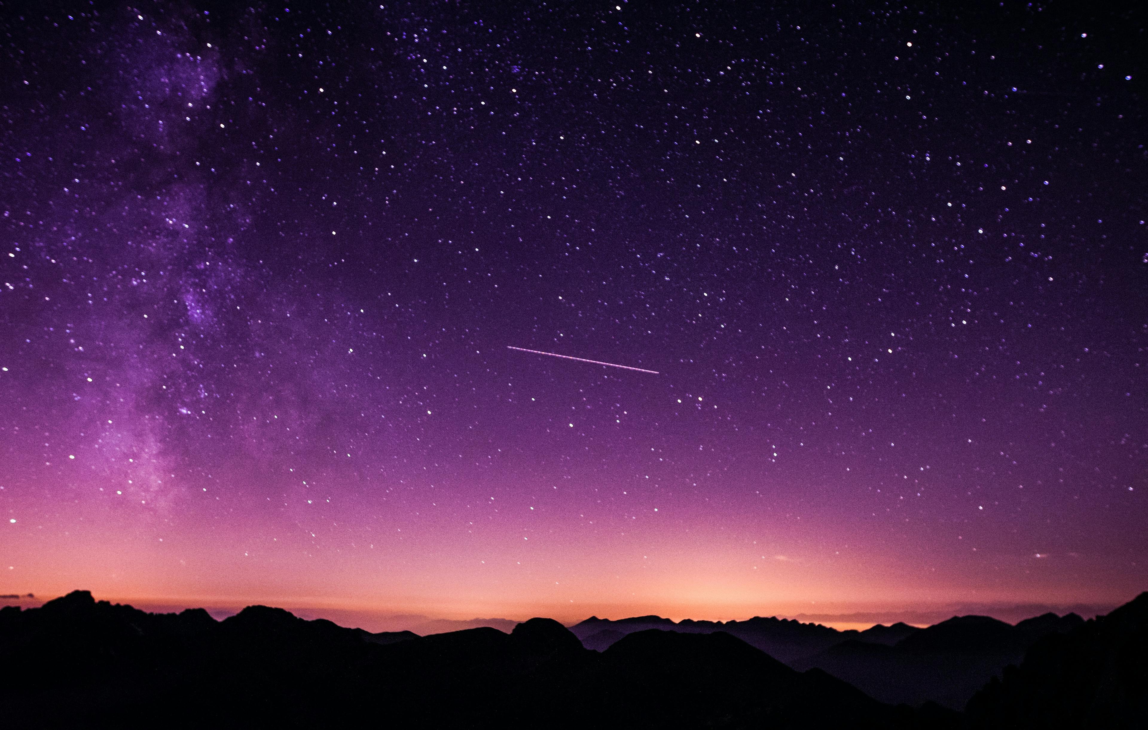 Night sky with stars and silouetted mountains