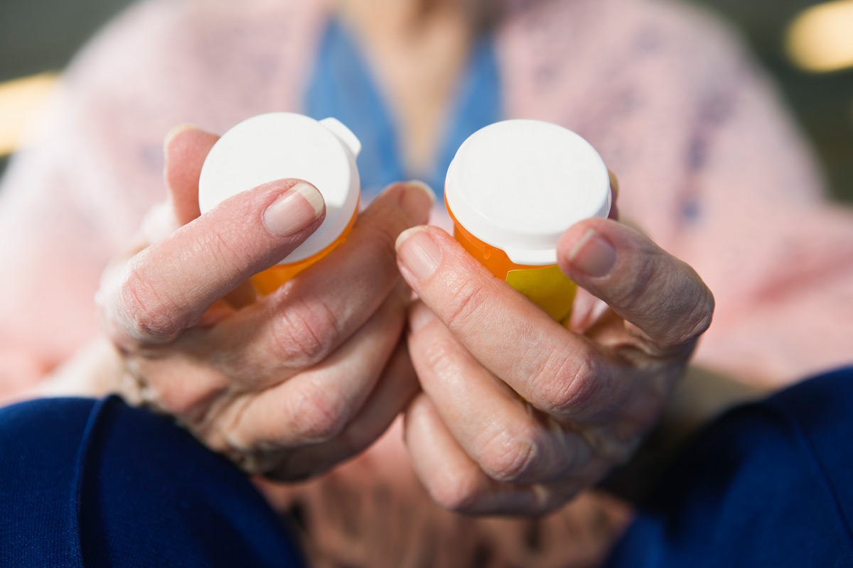 Close image of prescription bottles in hands